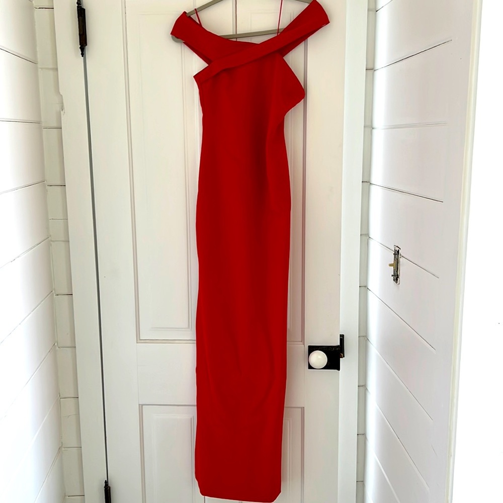 Full length, thigh slit each side. Likely